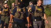 FBI agents walk down Florida Ave between 14th street NW and 13th street NW on August 13, 2025 in Washington, DC