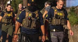 FBI agents walk down Florida Ave between 14th street NW and 13th street NW on August 13, 2025 in Washington, DC