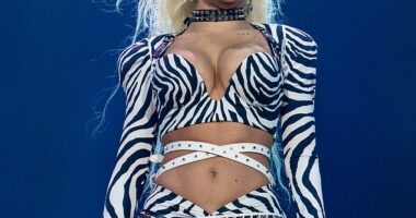 The singer added a red lip to complete her look, as well as a studded choker and belts to go with the outfit