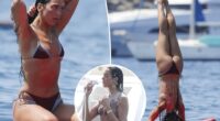 Dua Lipa flaunts her abs during paddleboard yoga in Ibiza