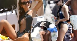 Emily Ratajkowski models cheeky cutout swimsuit on a boat in Italy