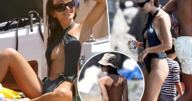 Emily Ratajkowski models cheeky cutout swimsuit on a boat in Italy