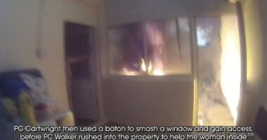 Two quick-thinking police officers smashed their way into a burning house to save a sleeping woman after spotting smoke while on a routine patrol