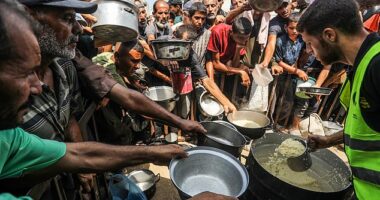Gaza City will be declared to be in famine for the first time by the international body responsible for monitoring world hunger, it has been reported. Pictured: People carried pots and pans to collect food from aid workers in Gaza on Sunday, August 10