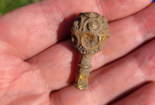 The gold object, which dates back to the 800s, is approximately one and a half inches long and has a decorative ornament on one end