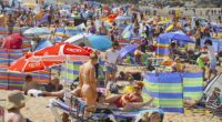 People working from home are reportedly clocking off early on Fridays during summer to grab pints at a beer garden (people are pictured on a beach in Newquay, Cornwall, on a busy Friday)