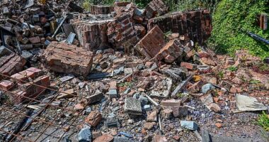 Fury has erupted after the remains of Britain's wonkiest pub were 'left to rot' (pictured) for two years after it was destroyed in a fire