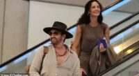 Gerard Butler and his girlfriend Morgan Brown weren't letting the stress of airport travel keep them from flashing a smile on Friday