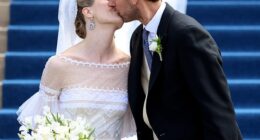 The happy couple (pictured) sealed their vows with a kiss on the steps of the cathedral after their wedding ceremony