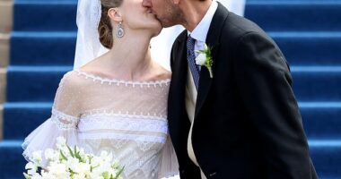 The happy couple (pictured) sealed their vows with a kiss on the steps of the cathedral after their wedding ceremony