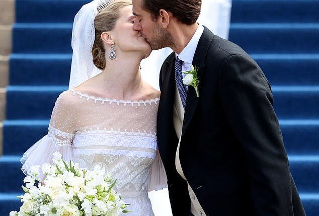 The happy couple (pictured) sealed their vows with a kiss on the steps of the cathedral after their wedding ceremony