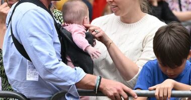 Princess Beatrice her husband Edoardo Mozzi (CL) and children Sienna, Athena and Christopher joins fans lining the Mall waiting to greet the bus carrying the England women's national football team during the homecoming victory parade near Buckingham Palace in London on July 29, 2025