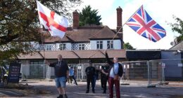Protesters wave flags outside the Bell Hotel following the major ruling
