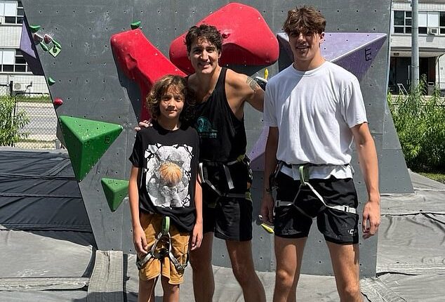 Trudeau ditches the suit for a sleeveless tank as he poses with sons Xavier and Hadrien at a climbing gym during their Canadian road trip