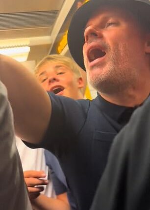 Jamie Carragher looked worse for wear as he joined Oasis fans on the tube following a one of the band's gigs at Wembley