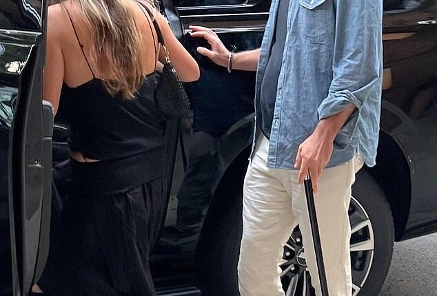 Jennifer Aniston 's new hypnotist hunk boyfriend Jim Curtis was seen with cane in hand as he limped on date with the A-lister