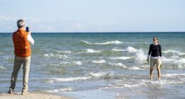 Royals are just like us! King Frederik was the dutiful Instagram husband snapping a picture of his wife Queen Mary standing in the choppy Grenen waters