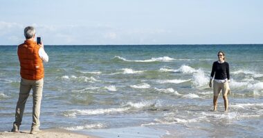Royals are just like us! King Frederik was the dutiful Instagram husband snapping a picture of his wife Queen Mary standing in the choppy Grenen waters