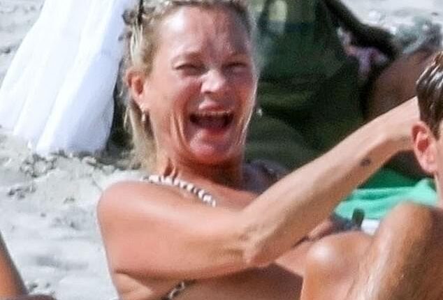 Kate Moss, 51, couldn't contain her giggles as she was surrounded by naked sunbathers on nudist beach in Ibiza on Thursday - before nearly baring all herself!