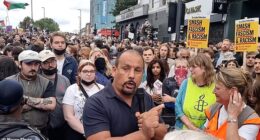 Ricky Jones, 58, who called for anti-migrant protesters' throats to be cut at an anti-racism rally has been cleared of encouraging violent disorder (he is pictured at the rally)