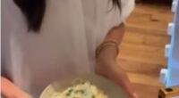 The Duchess of Sussex appeared to be in high spirits as she whipped up a pasta dish while donning a crisp white shirt