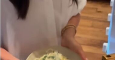 The Duchess of Sussex appeared to be in high spirits as she whipped up a pasta dish while donning a crisp white shirt