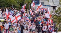 Crowds of anti-migrant demonstrators holding English flags and Union Jacks gather outside the Crowne Plaza hotel in West Drayton