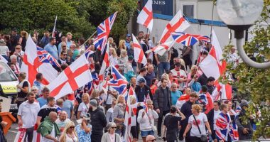 Crowds of anti-migrant demonstrators holding English flags and Union Jacks gather outside the Crowne Plaza hotel in West Drayton