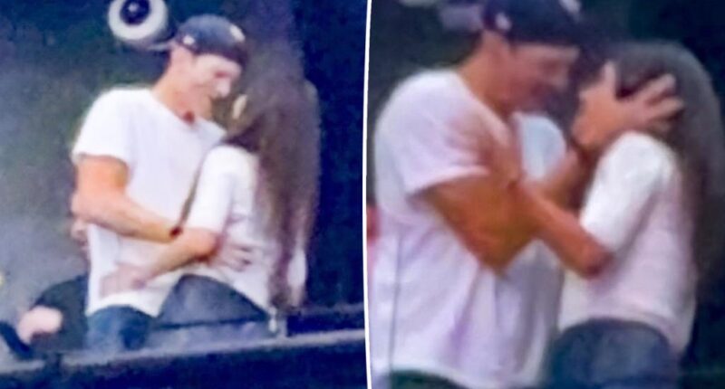 Mila Kunis and Ashton Kutcher show PDA at Backstreet Boys concert