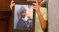 Family members who lost loved ones to distracted driving held up signs in their honor during the July 31 ceremony (pictured: a little boy holding a picture of Dale Willenberg, who died in 2017 when he was hit by a distracted driver)