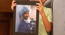 Family members who lost loved ones to distracted driving held up signs in their honor during the July 31 ceremony (pictured: a little boy holding a picture of Dale Willenberg, who died in 2017 when he was hit by a distracted driver)