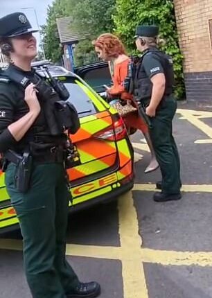 Police escort two drag artists away from Drag Queen Story Time at Holywood Arches Library in Belfast