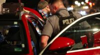 Troops with the National Guard arrived into the capital late on Tuesday night in a bid by the White House to curb violent crime, a US Marshal can be seen searching a vehicle on Tuesday