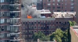 A massive fire broke out on the rooftop of 305 E 95th Street on Manhattan's Upper East Side