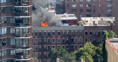 A massive fire broke out on the rooftop of 305 E 95th Street on Manhattan's Upper East Side
