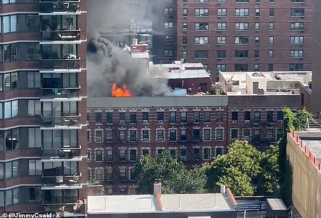A massive fire broke out on the rooftop of 305 E 95th Street on Manhattan's Upper East Side