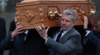 Patrick looked bereft as he carried Mary's coffin through his home village, where he was joined by close family and friends at the Church of the Sacred Heart
