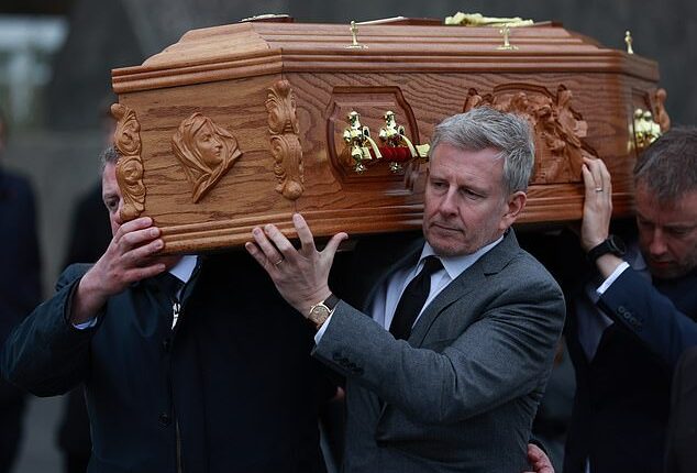 Patrick looked bereft as he carried Mary's coffin through his home village, where he was joined by close family and friends at the Church of the Sacred Heart