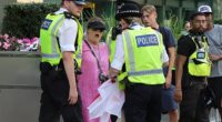 'Pink Lady' anti-migrant protesters have clashed with police outside a hotel housing asylum seekers in Canary Wharf today in the latest wave of demonstrations