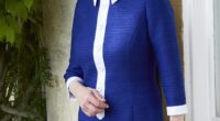 The photograph released to mark the Princess Royal's 75th birthday - Princess Anne wears a blue and white dress while leaning by a windowsill at her private residence, Gatcombe Park