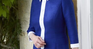 The photograph released to mark the Princess Royal's 75th birthday - Princess Anne wears a blue and white dress while leaning by a windowsill at her private residence, Gatcombe Park