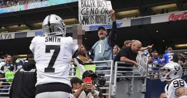 Las Vegas Raiders quarterback Geno Smith responds to a Seattle Seahawks fan