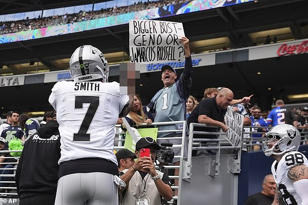 Las Vegas Raiders quarterback Geno Smith responds to a Seattle Seahawks fan