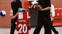 Man United captain Bruno Fernandes (left) and defender Diogo Dalot (right) pictured outside Anfield last month to pay tribute to Portugal team-mate Diogo Jota following his tragic death
