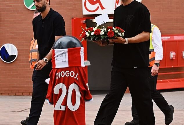 Man United captain Bruno Fernandes (left) and defender Diogo Dalot (right) pictured outside Anfield last month to pay tribute to Portugal team-mate Diogo Jota following his tragic death