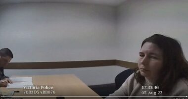 Erin Patterson looks to the camera as two Homicide Squad detectives conclude her record of interview