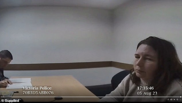 Erin Patterson looks to the camera as two Homicide Squad detectives conclude her record of interview