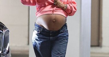 Rihanna proved she has maternity style nailed as she stepped out in low-slung jeans with a pink hoodie and her blossoming bump on full display on Monday