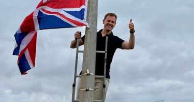 Robert Jenrick scaled a ladder in his Newark constituency to hang Union Jacks from lamp-posts