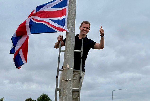 Robert Jenrick scaled a ladder in his Newark constituency to hang Union Jacks from lamp-posts